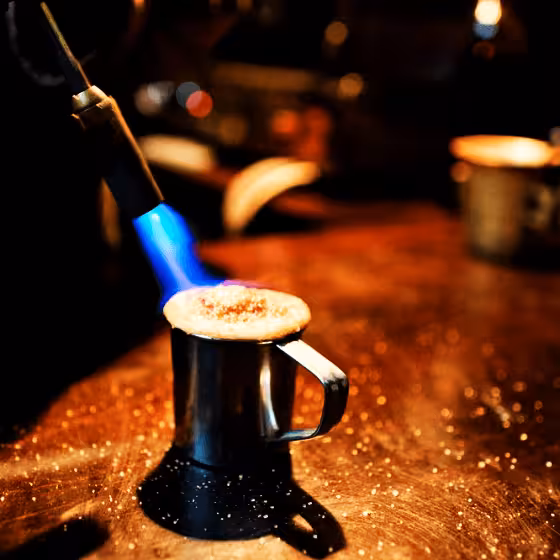 a flaming coffee prepared with a blowtorch in lviv coffee mine