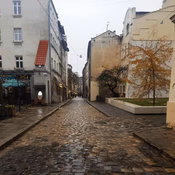looking down a cobblestone street from the space of synagogues memorial in lviv