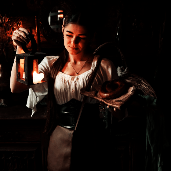 a ukrainian girl wearing mediaeval clothes preparing to serve diners in the 5th. dungeon restaurant lviv